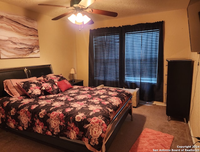 carpeted bedroom featuring a textured ceiling and ceiling fan