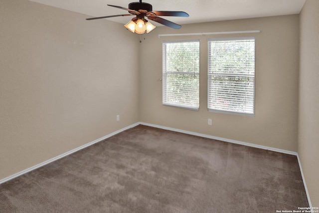 carpeted spare room with ceiling fan