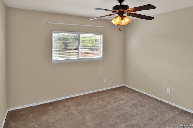 carpeted spare room featuring ceiling fan