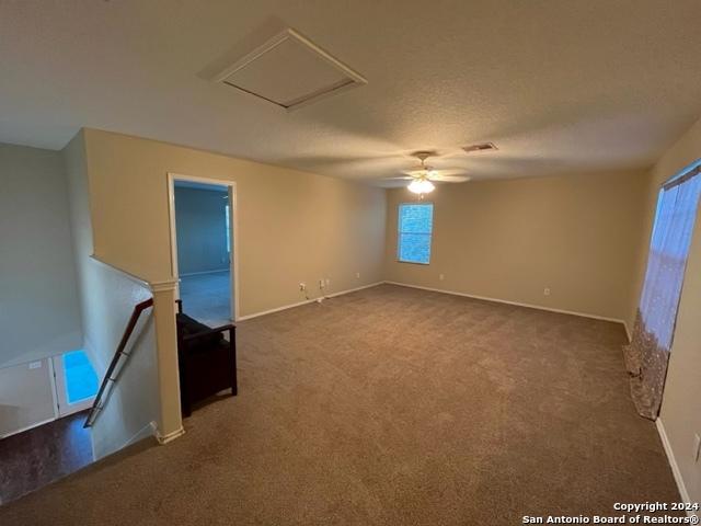 spare room with carpet flooring and ceiling fan