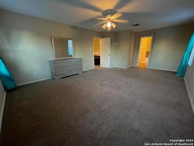 unfurnished bedroom featuring carpet, ceiling fan, and ensuite bath