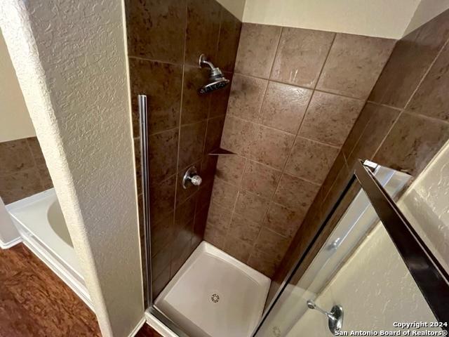 bathroom with shower with separate bathtub