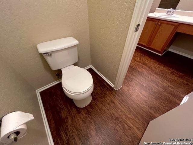 bathroom featuring hardwood / wood-style floors, vanity, and toilet