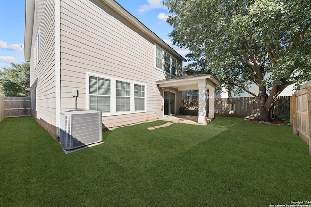 back of house with a yard and cooling unit