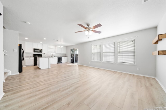 unfurnished living room with ceiling fan, light hardwood / wood-style floors, and a textured ceiling