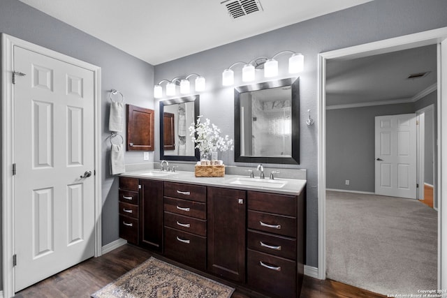 bathroom featuring hardwood / wood-style floors, vanity, and ornamental molding