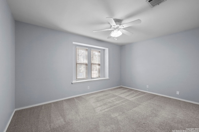 empty room with ceiling fan and light colored carpet