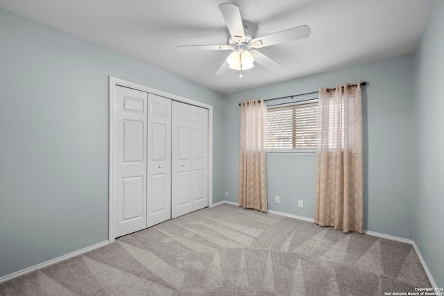 unfurnished bedroom with ceiling fan, light colored carpet, and a closet