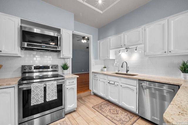 kitchen featuring sink, white cabinets, and appliances with stainless steel finishes