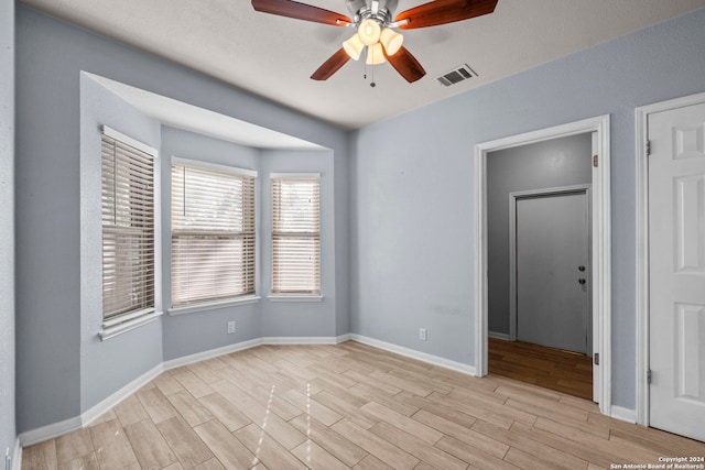 unfurnished room with ceiling fan and light hardwood / wood-style floors