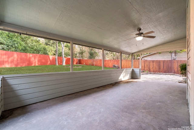 unfurnished sunroom with ceiling fan and vaulted ceiling