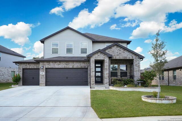 view of front of home with a garage and a front yard