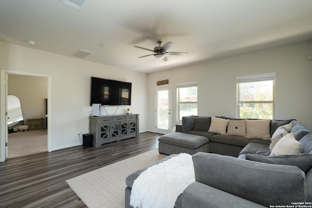 living room with ceiling fan and dark wood-type flooring