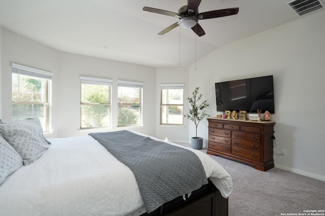 bedroom with multiple windows, carpet floors, vaulted ceiling, and ceiling fan