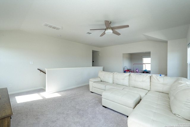 carpeted living room with ceiling fan and lofted ceiling