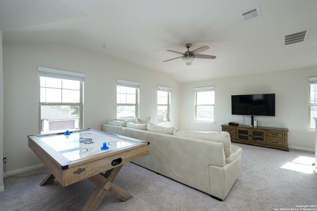 living room featuring light colored carpet, vaulted ceiling, and ceiling fan