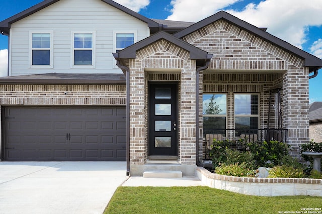 view of front of house featuring a porch and a garage