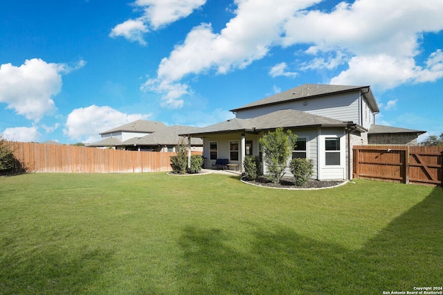 rear view of property with a lawn