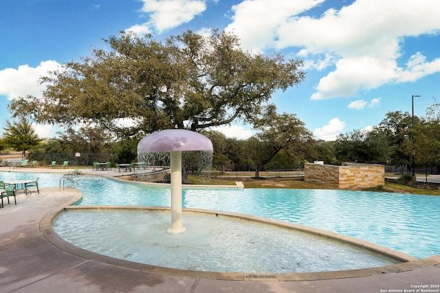 view of swimming pool featuring pool water feature