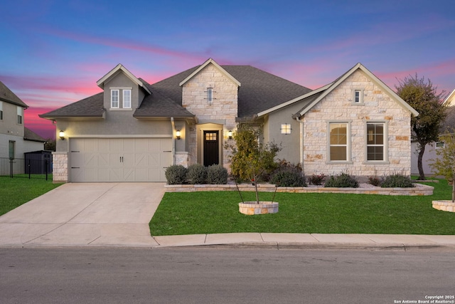 view of front facade with a garage and a yard