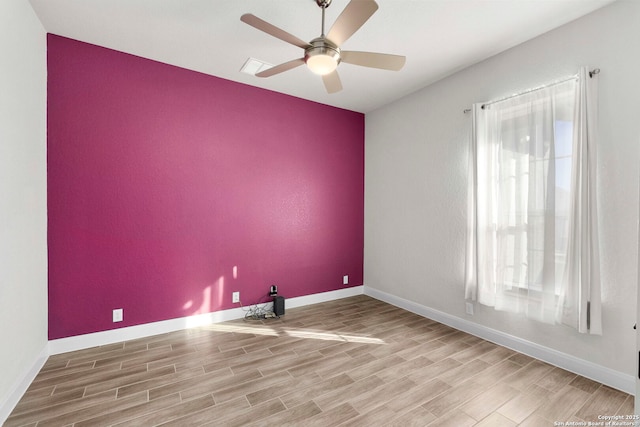 spare room with ceiling fan and wood-type flooring