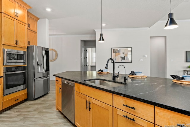 kitchen featuring hanging light fixtures, crown molding, sink, and stainless steel appliances