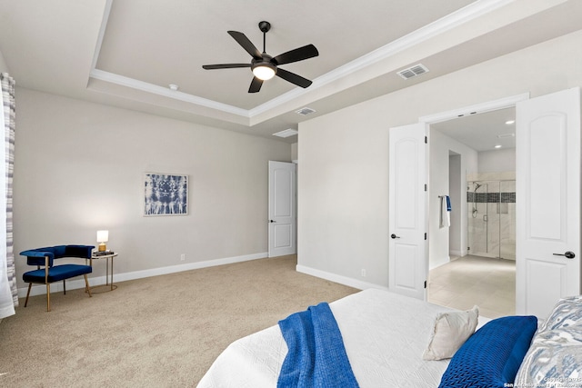 carpeted bedroom with a tray ceiling, ceiling fan, and ornamental molding