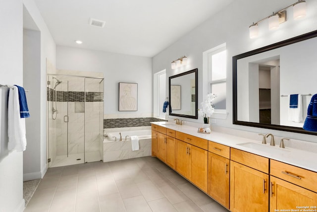 bathroom featuring tile patterned flooring, shower with separate bathtub, and vanity