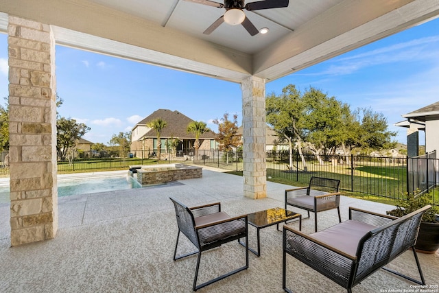 view of patio / terrace with a fenced in pool, ceiling fan, pool water feature, and an outdoor hangout area