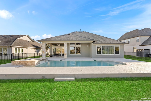 view of pool featuring an in ground hot tub, a patio, and a lawn