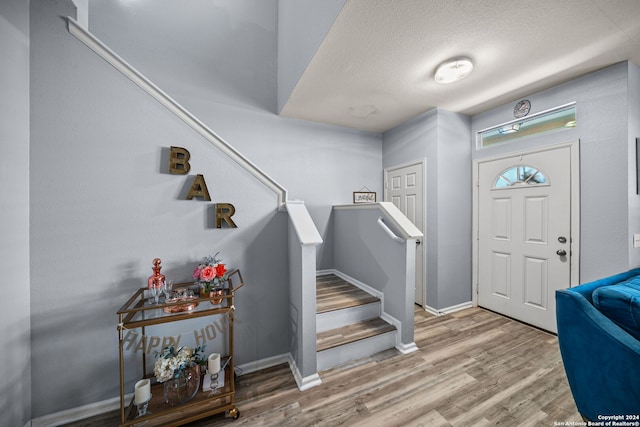 foyer featuring a textured ceiling and hardwood / wood-style flooring