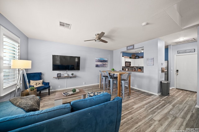 living room with hardwood / wood-style flooring and ceiling fan