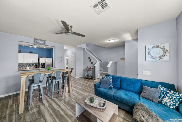 living room with ceiling fan and wood-type flooring