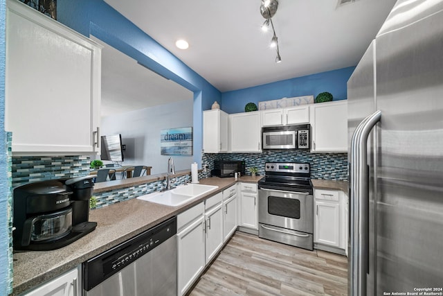 kitchen featuring white cabinets, light hardwood / wood-style floors, sink, and stainless steel appliances