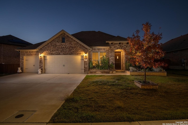 view of front of house with a yard and a garage