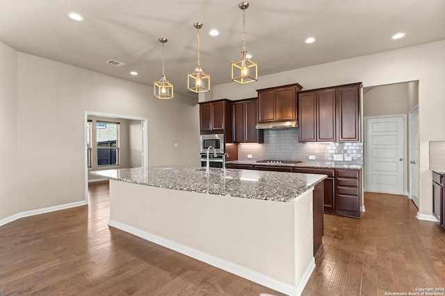 kitchen featuring sink, dark hardwood / wood-style flooring, decorative light fixtures, a center island with sink, and appliances with stainless steel finishes