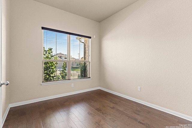 empty room featuring dark hardwood / wood-style flooring