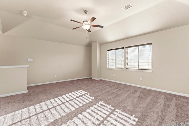 empty room with light carpet, ceiling fan, and lofted ceiling