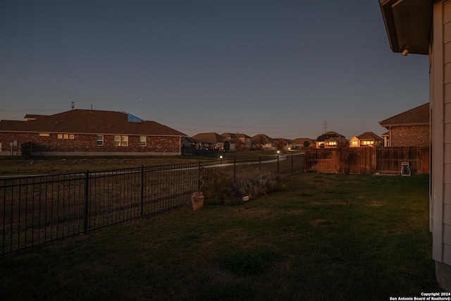 view of yard at dusk