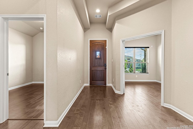 entryway with lofted ceiling and dark hardwood / wood-style floors