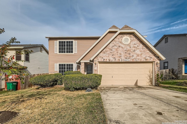 front facade featuring a front lawn and a garage