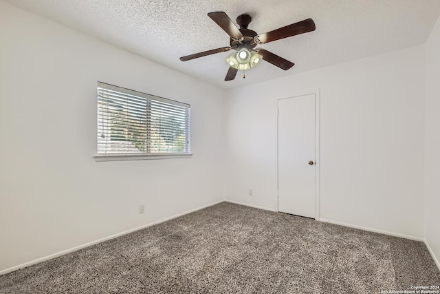 carpeted spare room featuring ceiling fan and a textured ceiling