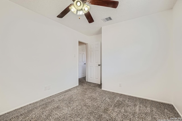 spare room featuring a textured ceiling, carpet floors, and ceiling fan