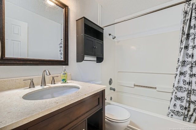 full bathroom featuring vanity, shower / bath combo, toilet, and a textured ceiling