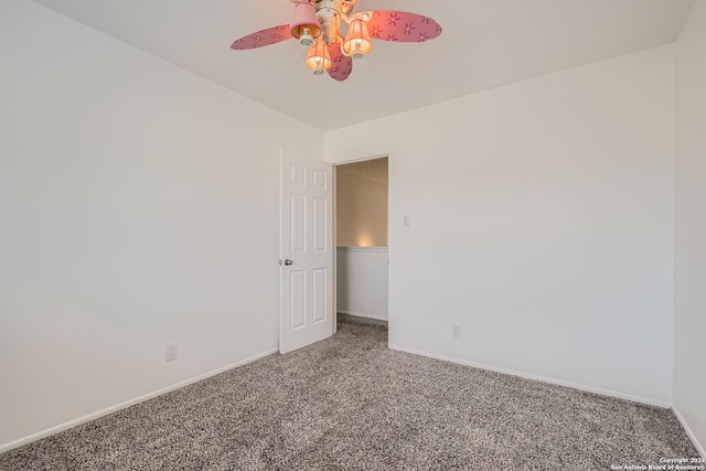 empty room with ceiling fan and carpet floors