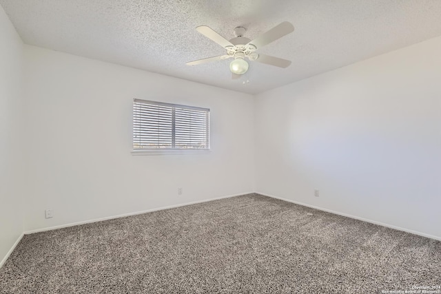 carpeted empty room with ceiling fan and a textured ceiling