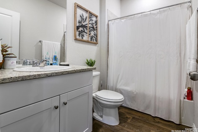 full bathroom with hardwood / wood-style flooring, shower / bath combination with curtain, toilet, and vanity