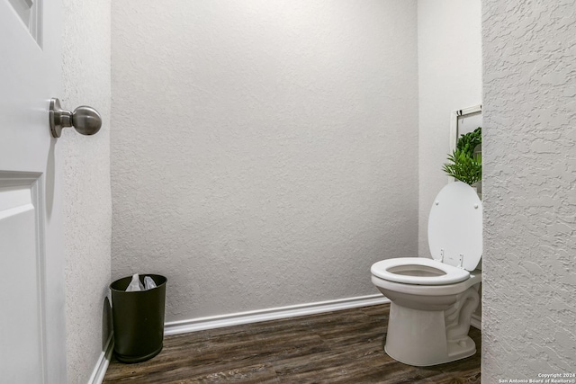 bathroom featuring hardwood / wood-style floors and toilet