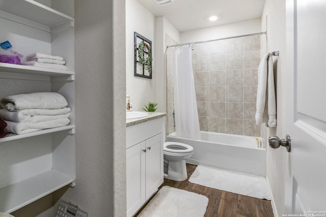 full bathroom featuring hardwood / wood-style flooring, vanity, toilet, and shower / bath combo with shower curtain