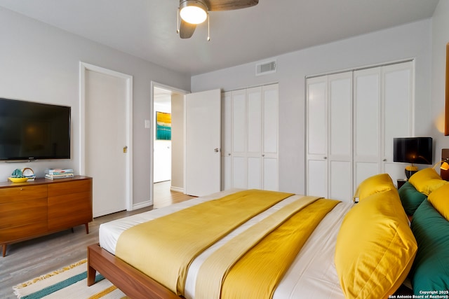 8038 Broadway Unit 225L, San Antonio, TX 78209 - bedroom featuring multiple closets, light wood-type flooring, and a ceiling fan